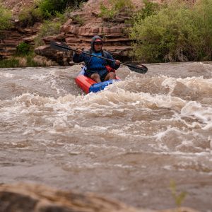 Jaron Segay hitting the first major rapid on the Dolores River in his learn to packraft course..